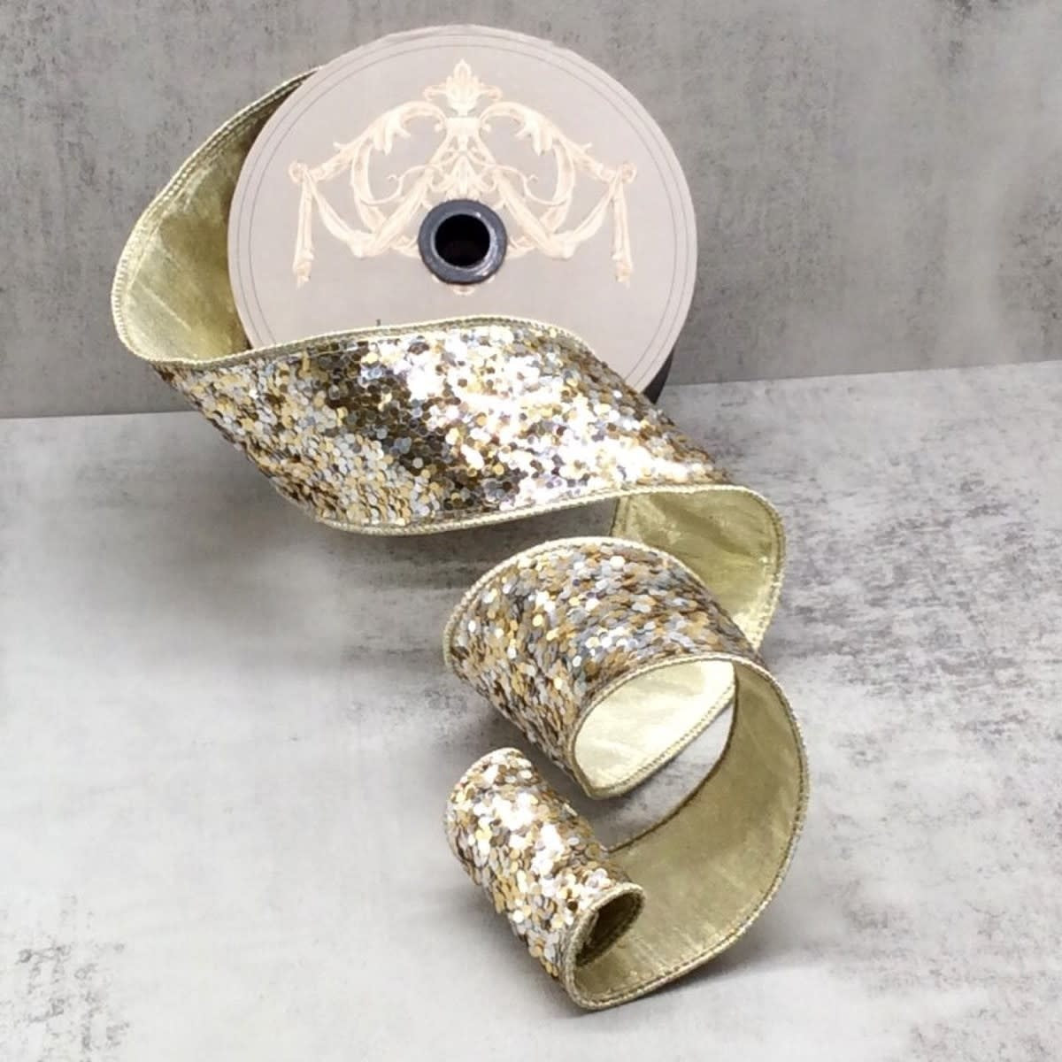 2.5-inch wide decorative ribbon roll featuring a silver and gold sequin glitter pattern.