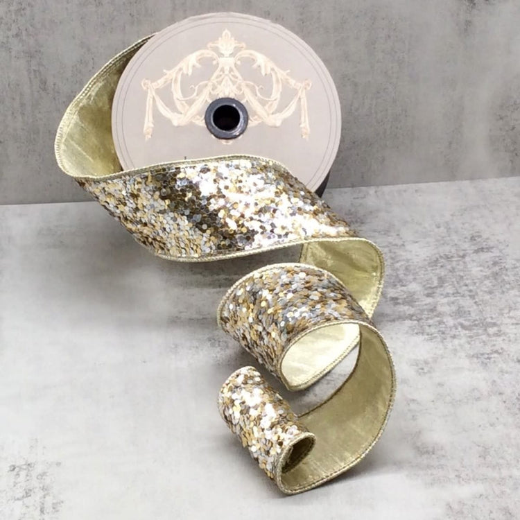 2.5-inch wide decorative ribbon roll featuring a silver and gold sequin glitter pattern.