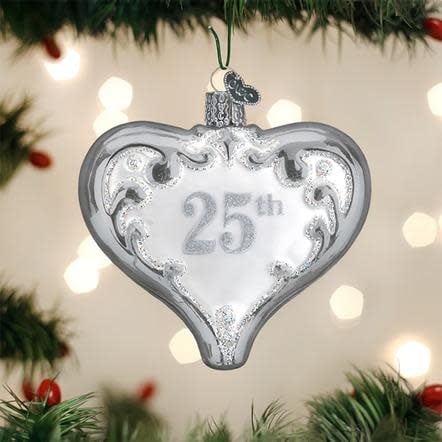 Silver heart-shaped glass ornament with 25th anniversary text and decorative glitter accents.