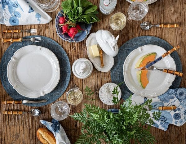 White scalloped cocktail plate with berry accents in flared silhouette