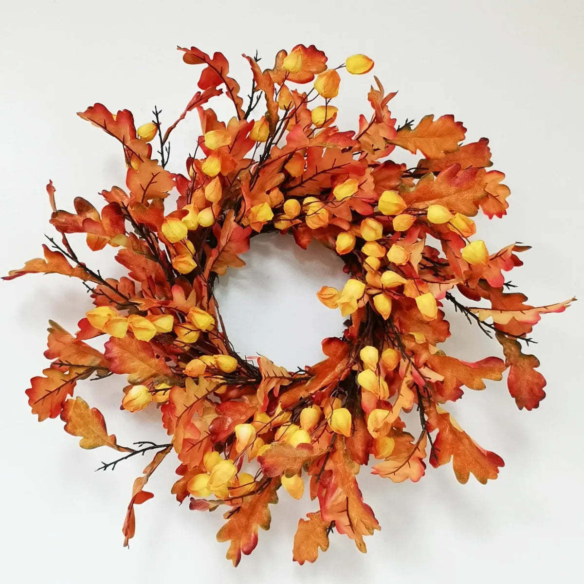 Oak leaf wreath with lantern accent in warm brown tones