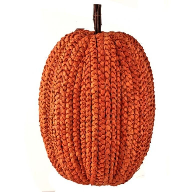Large orange basket weave pumpkin with a twig stem and ribbed texture.
