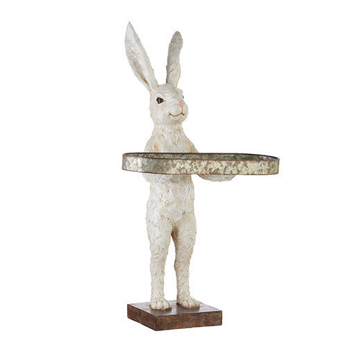 White resin rabbit figurine standing on a wooden base, holding an oval iron tray.