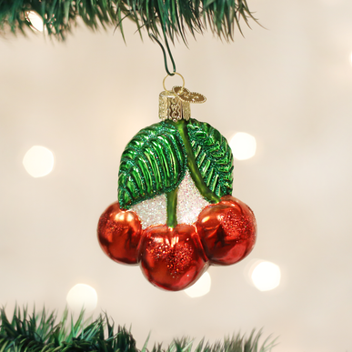 Mouth-blown glass cherry ornament with silver interior and hand-painted colorful lacquers.