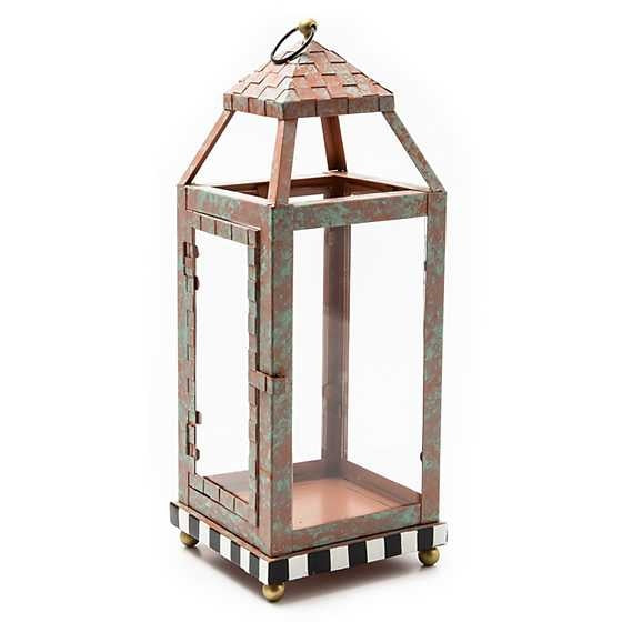 Small Check It Out lantern with verdigris copper iron finish featuring glass panels holding a pillar candle.