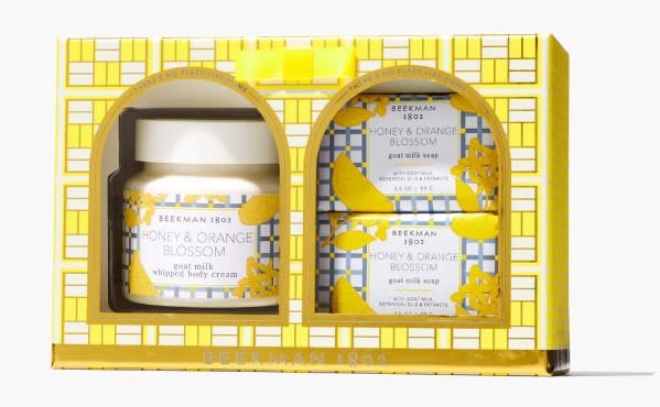 Gift set with two honey-colored soaps and a cream jar featuring apricot, white nectarine, mimosa, pink peony, apple peel, and vanilla scents.