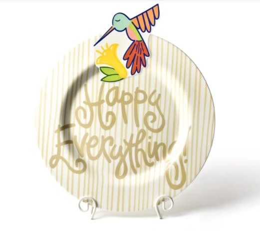 Ceramic wall hook with a cheerful hummingbird painted in spring colors on a white background.