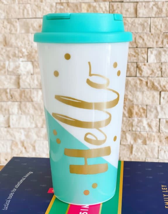 Black double-wall tumbler with flip lid featuring Hello Kitty graphic