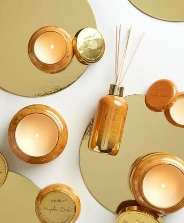 Glass reed diffuser bottle with white pumpkin, gingersnap vanilla scent, wrapped in champagne glitter.