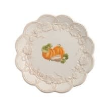 Round stoneware harvest platter in earthy tones with a rustic rim.