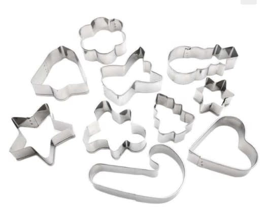 Stainless steel Christmas cookie cutter set with festive shapes in a metal container.