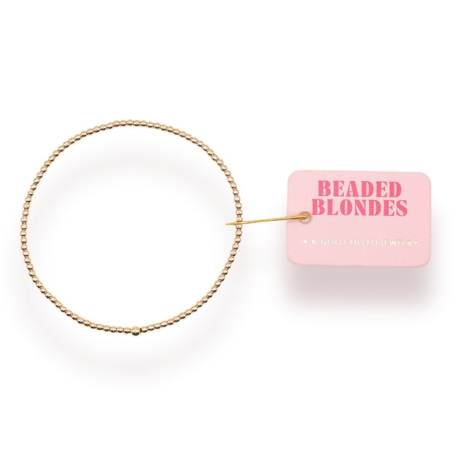 Elastic gold beaded bracelet with small round beads on a stretch cord.