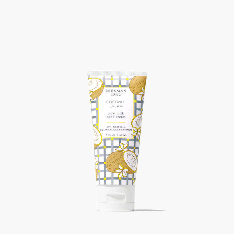 Beekman 1802 Coconut Cream goat milk hand cream in a 2 oz squeeze tube with a blue plaid pattern.