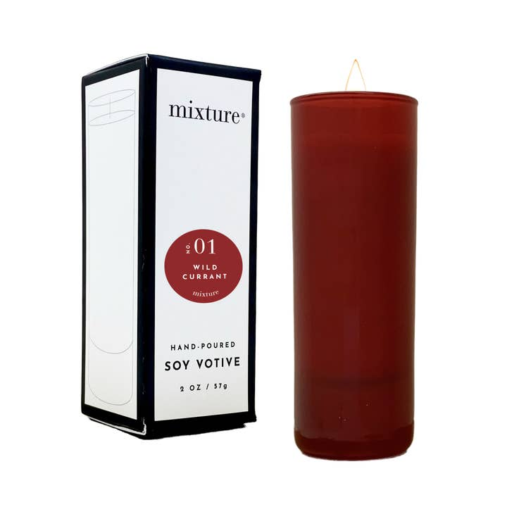 2 oz Red Wild Currant Soy Votive candle in a tall glass cylinder next to its white and black box.