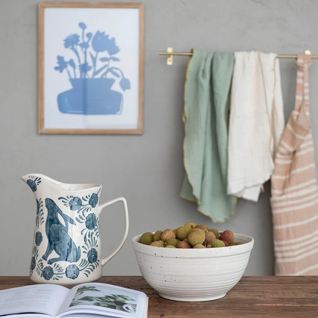 3-quart stoneware pitcher with hand-painted blue rabbit and floral patterns on a cream background.