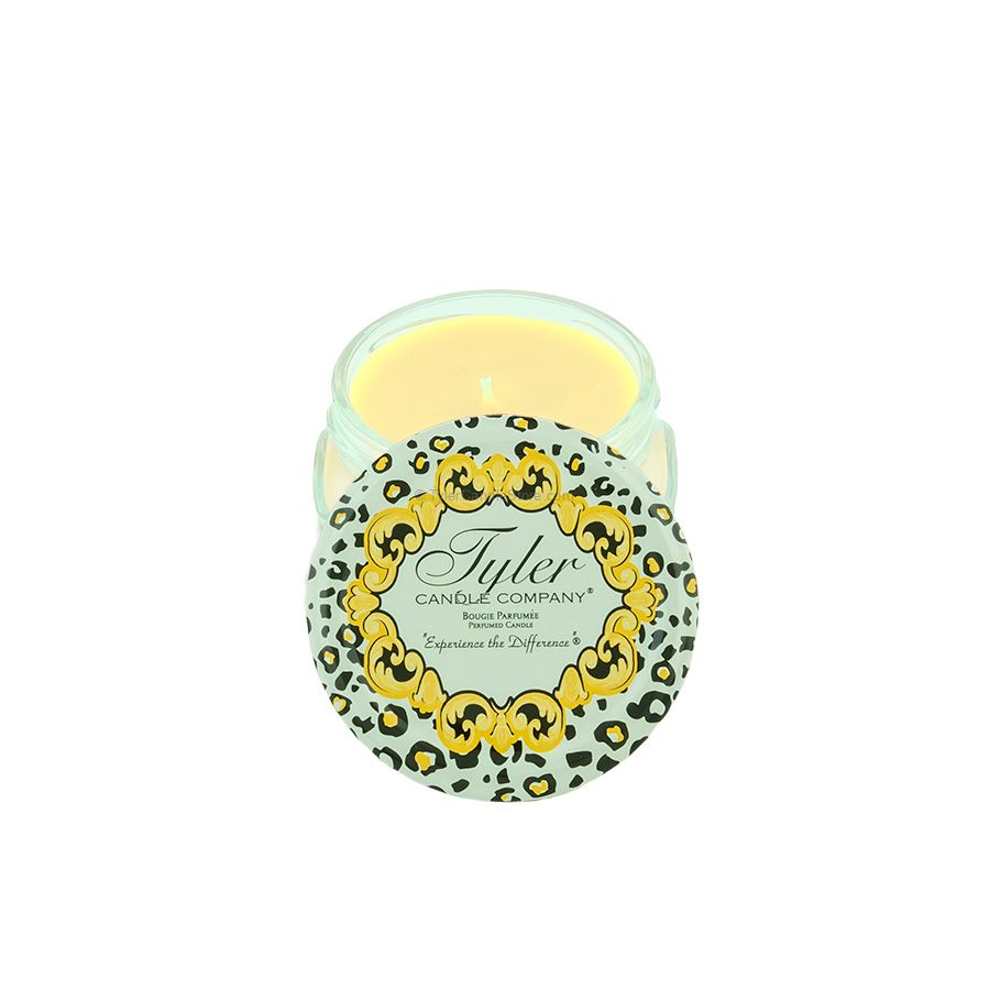 A small Tyler Candle Company jar with a light green leopard print lid and yellow wax.