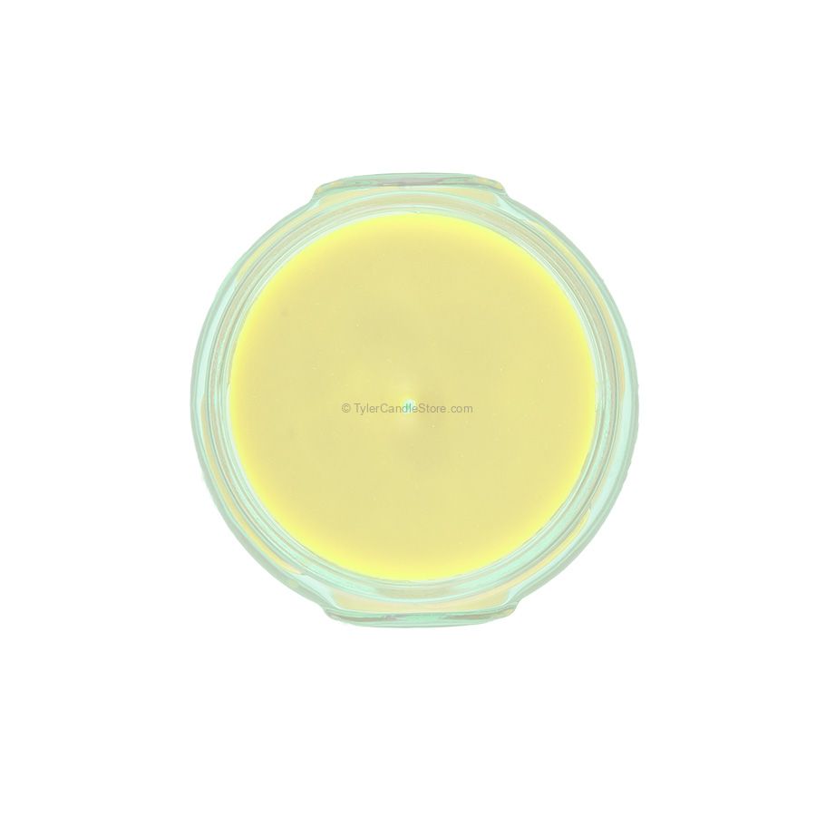 Top-down view of a 3.4oz yellow soy-paraffin blend candle in a clear glass jar.