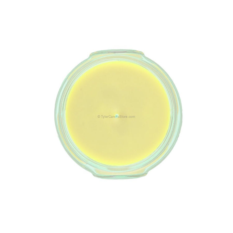 Top-down view of a 3.4oz yellow soy-paraffin blend candle in a clear glass jar.