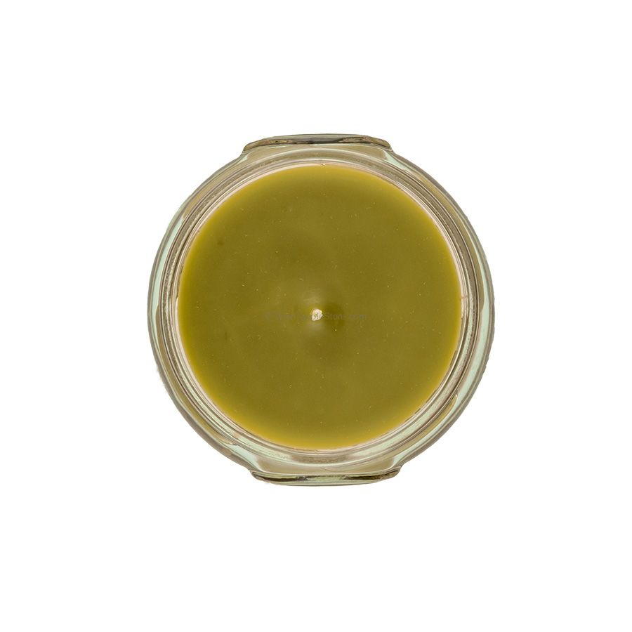 Top-down view of a 3.4oz Tyler candle in a clear glass jar with green wax and a single wick.