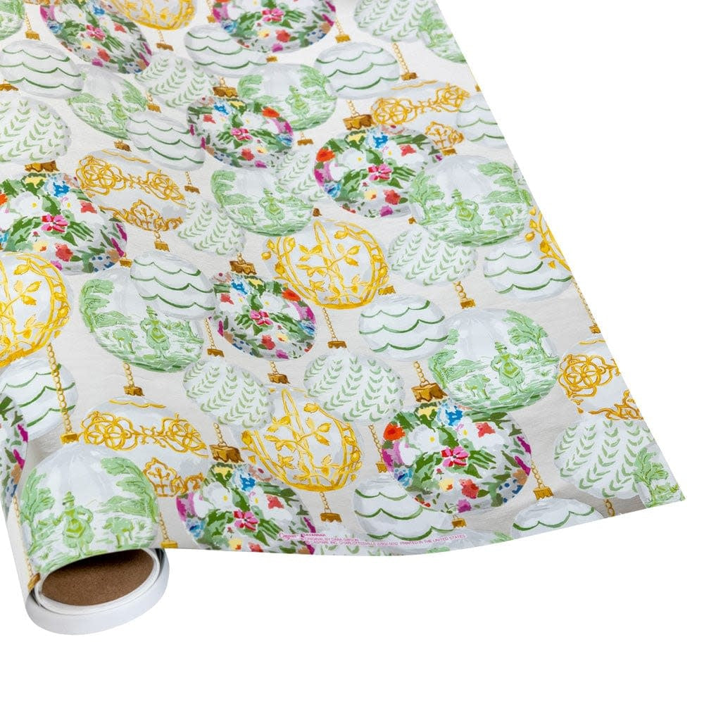 Roll of gift wrap featuring a pattern of green, gold, and floral Christmas ornaments.