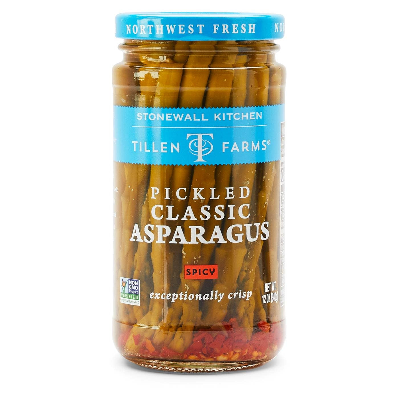 Jar of spicy pickled asparagus spears in red brine with crushed red chilies.