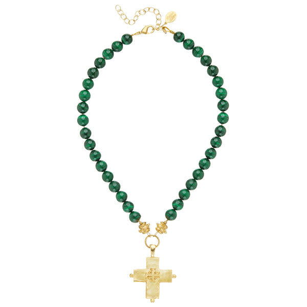 Bold green Magellan cross necklace with a simple pendant on a chain.
