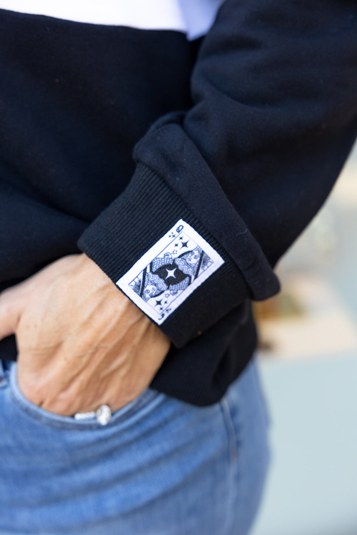 Orange and black quarter-zip sweatshirt with colorblocking representing OSU team colors.