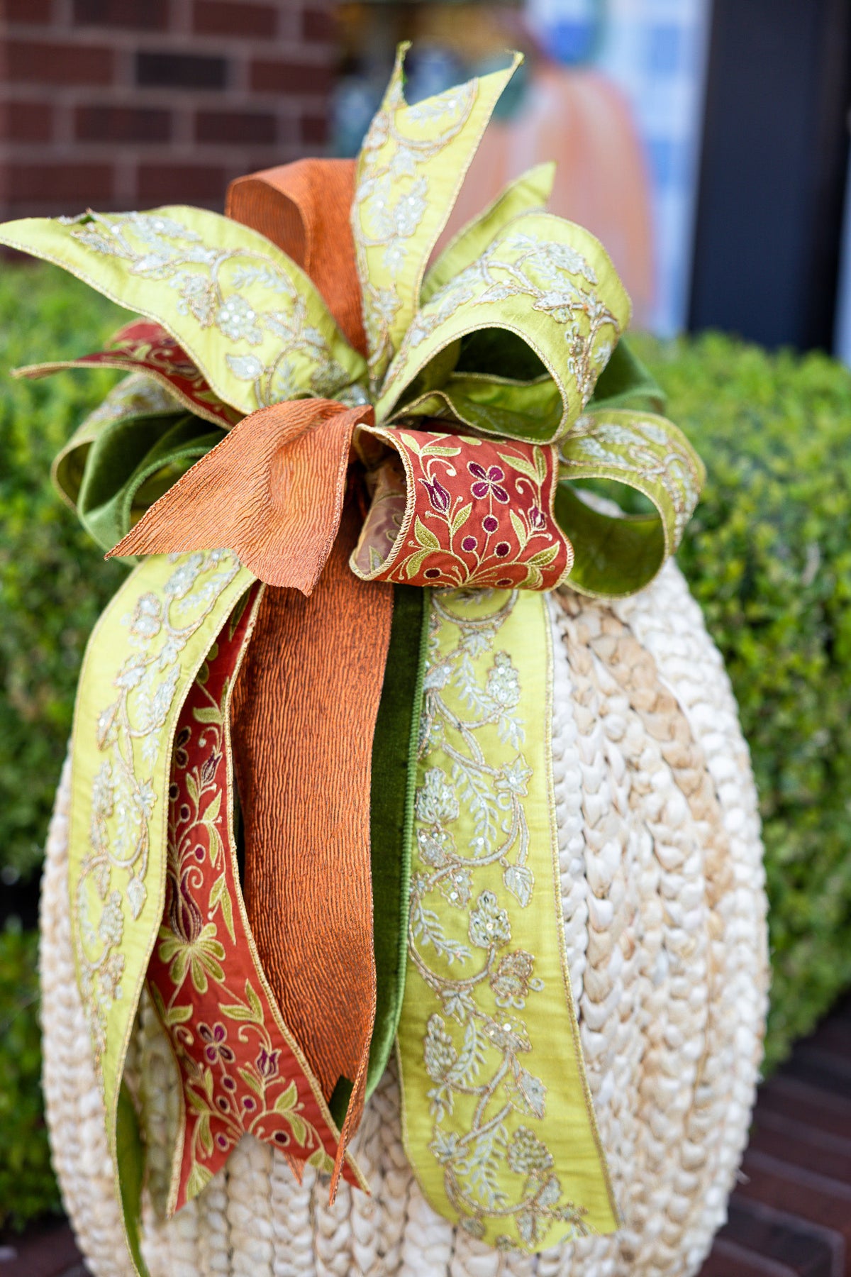 Large cream ribbon bow with a central gold accent pin