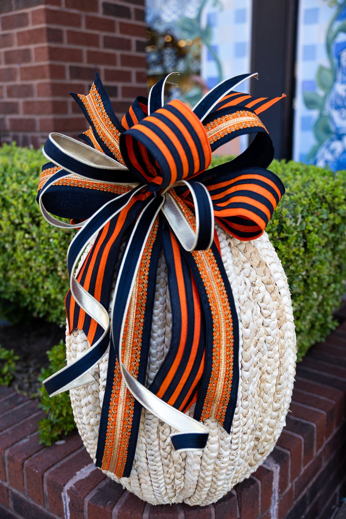 Large orange and black striped ribbon bow with a classic looped silhouette