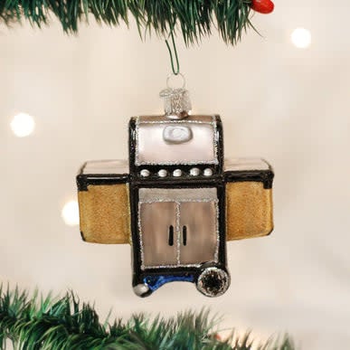 Small black barbecue grill ornament with silver handle detail