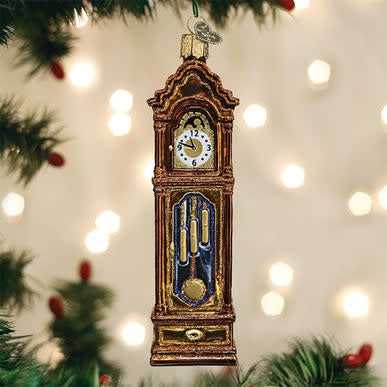 Tall wooden grandfather clock with classic arched hood and pendulum visible.