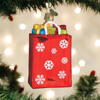 Red holiday shopping bag ornament with gold handle.