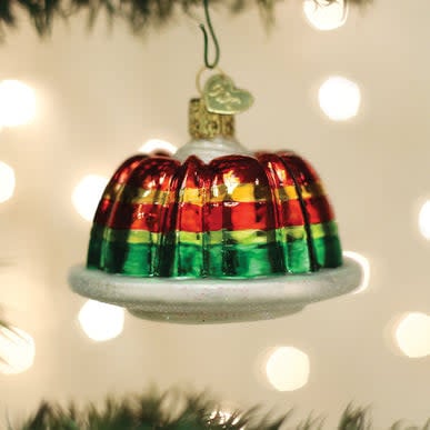 Festive gelatin mold ornament shaped like a vintage dessert cup with red and white striped pattern.