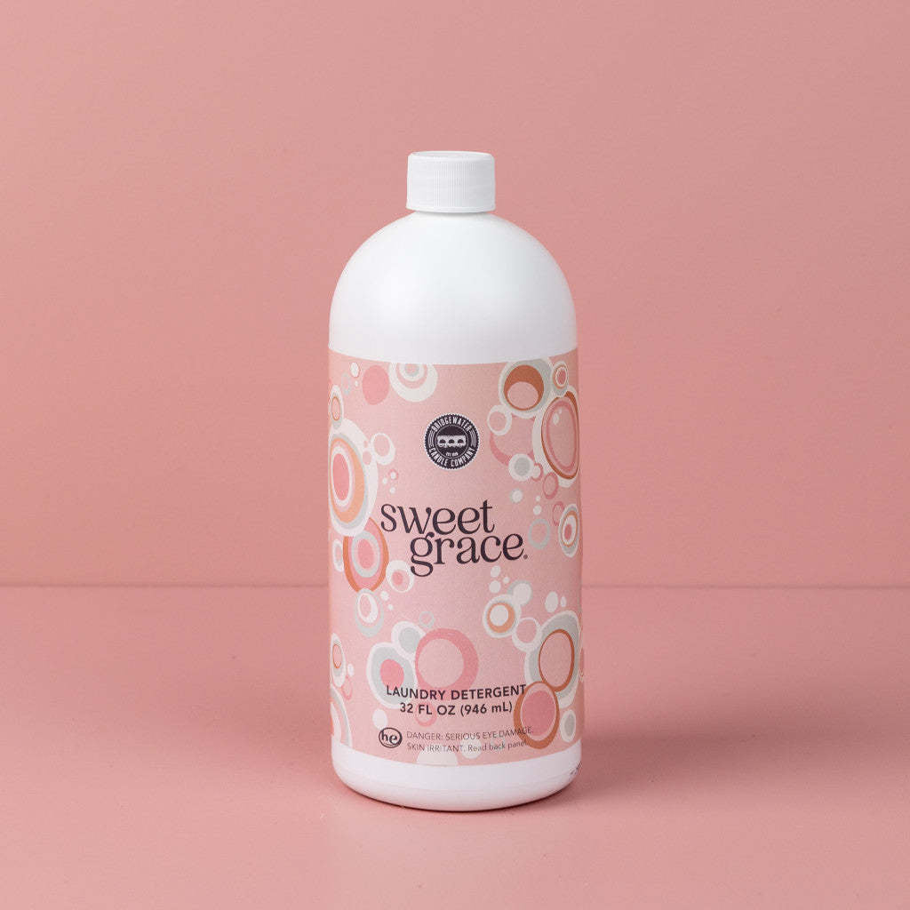 32oz bottle of Sweet Grace laundry detergent with a white cap and pink bubble-patterned label.