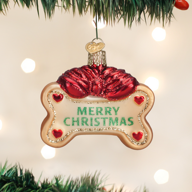 Dog Treat ornament in white ceramic with a brown bone-shaped treat hanging from its bottom.