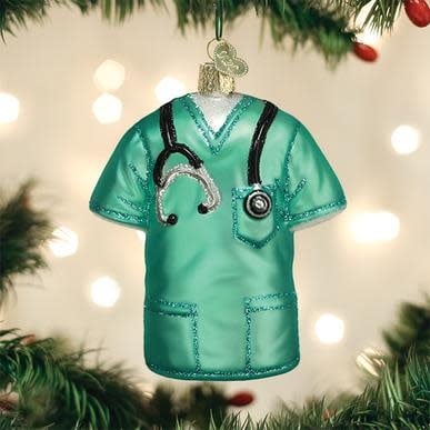 Hand-blown glass ornament shaped like medical scrubs with silver finish and hand-painted glitter details.