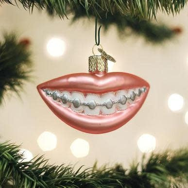 Braces Ornament: A small decorative item shaped like dental braces in a metallic finish.