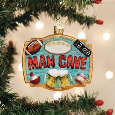 Man Cave glass ornament featuring a football, remote, beer mugs, and baseball on a blue background.