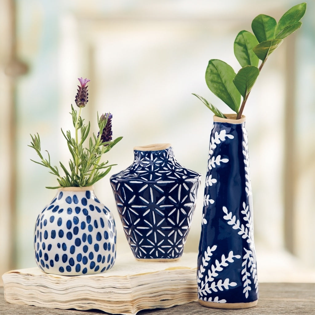 Blue stoneware bud vase with debossed mosaic pattern and exposed rim.