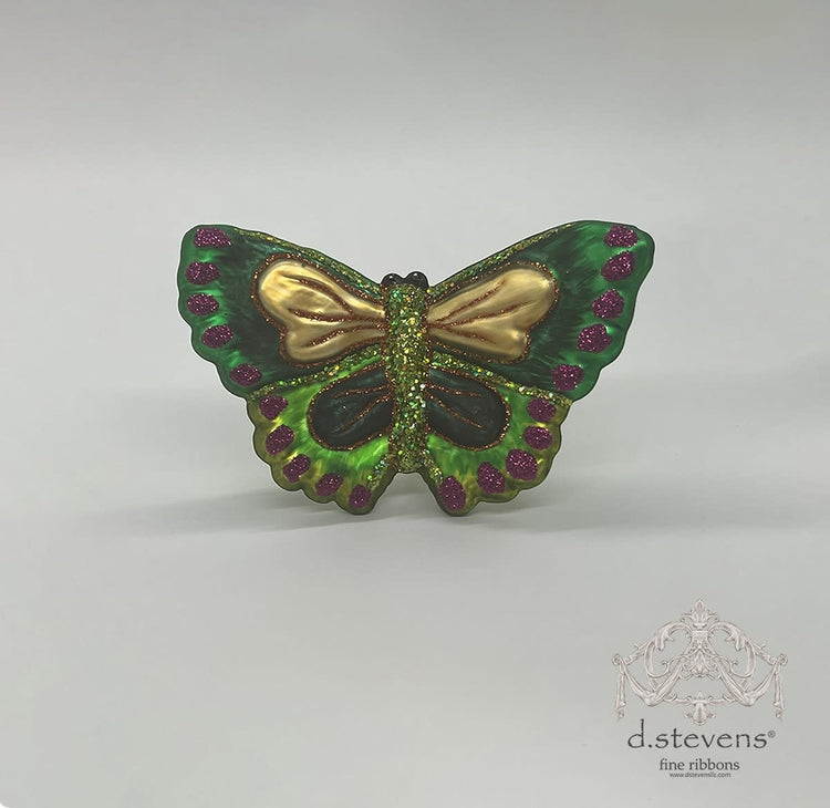 3.75-inch green glass butterfly ornament with gold wings and purple glitter accents.