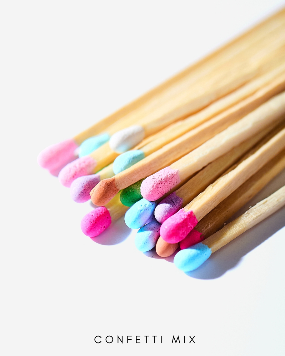 A bundle of 3-inch wooden safety matches with colorful confetti-mix tips on a white background.
