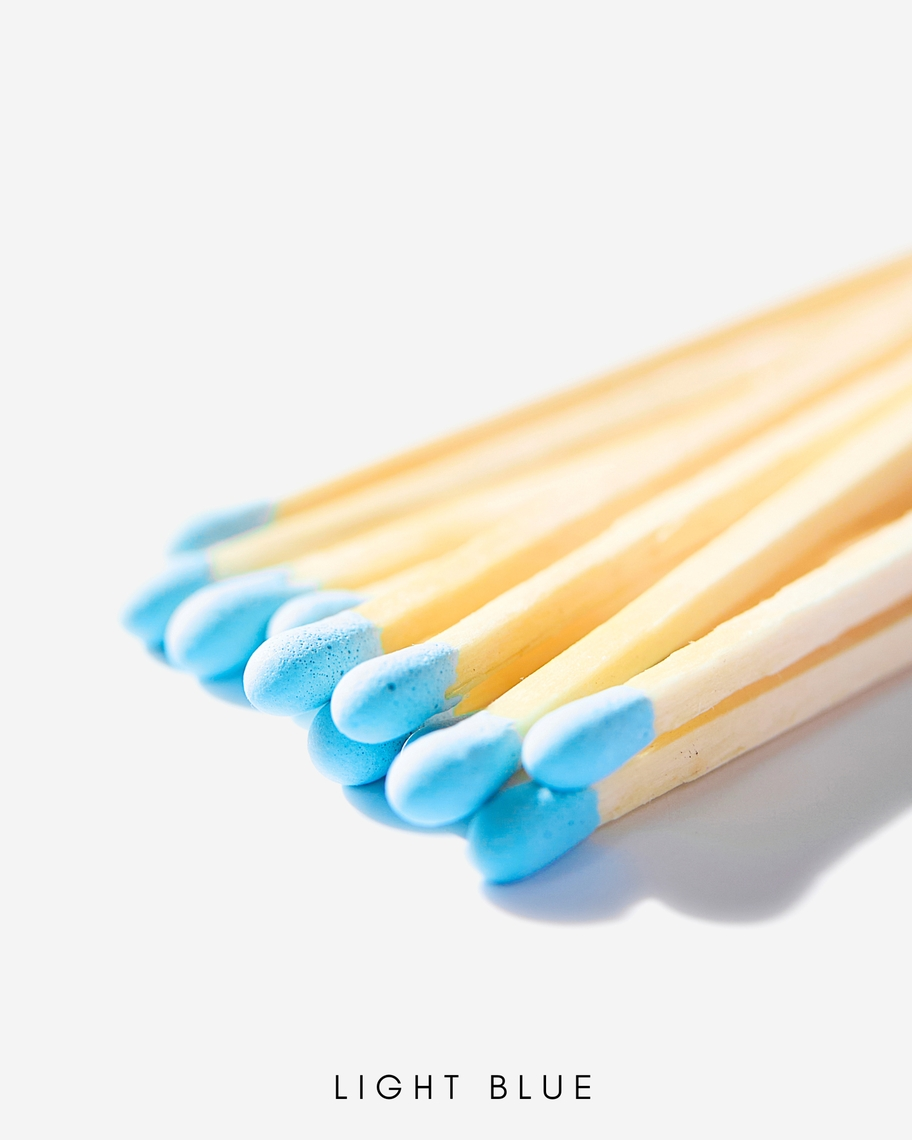 Close-up of 3-inch safety match sticks with light blue tips and natural wood stems.