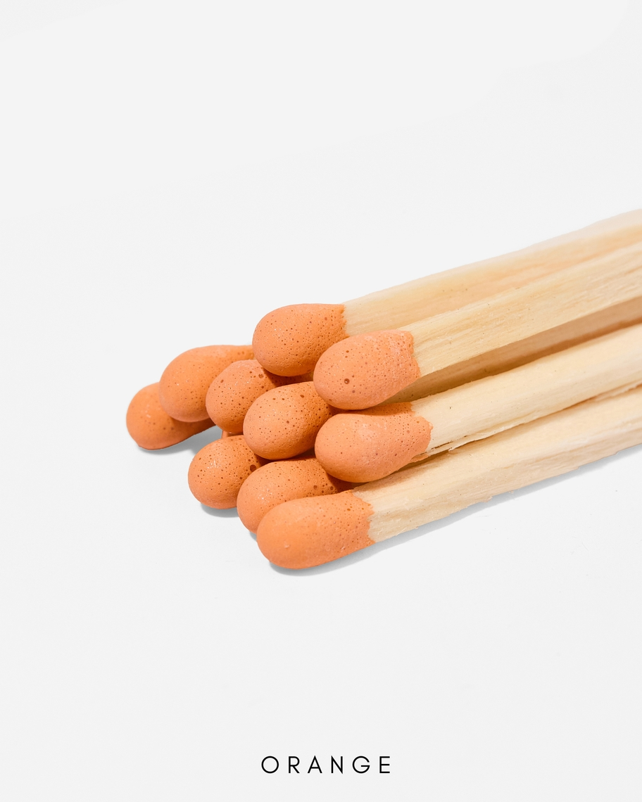 Close-up of 3-inch safety matches with orange tips and natural wood sticks.