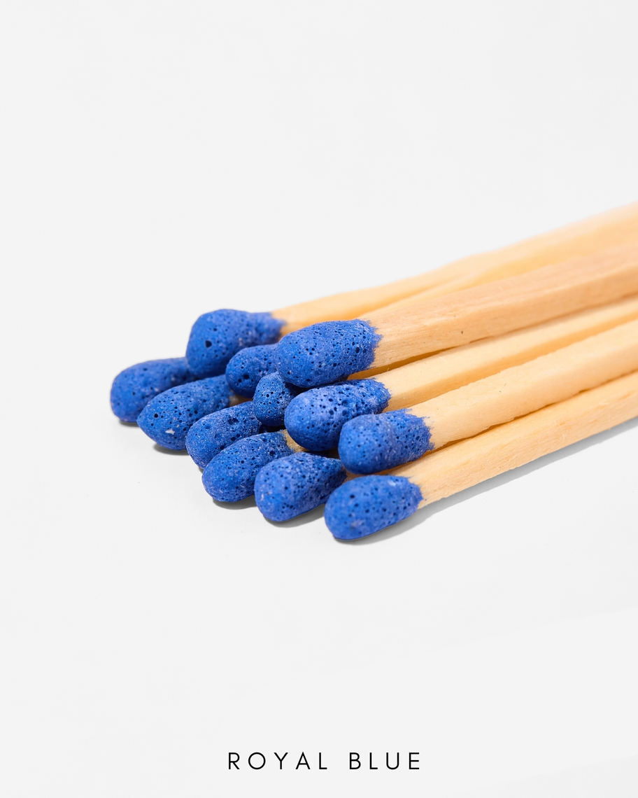Close-up of 3-inch safety matches with royal blue tips and natural wood sticks.