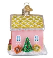 Red starburst-shaped cottage ornament with white polka dots on a gold string.