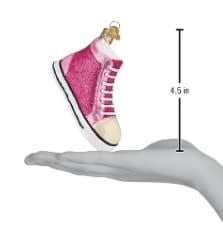 Black fashion sneaker ornament with white laces on a plain background.