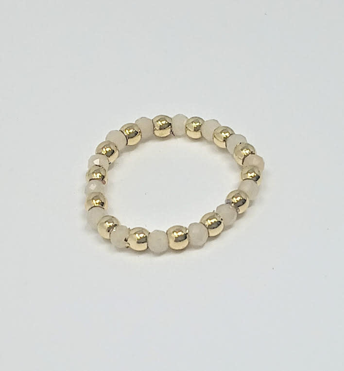 A beaded ring featuring alternating 3mm gold-tone balls and light-colored semi-precious stones.