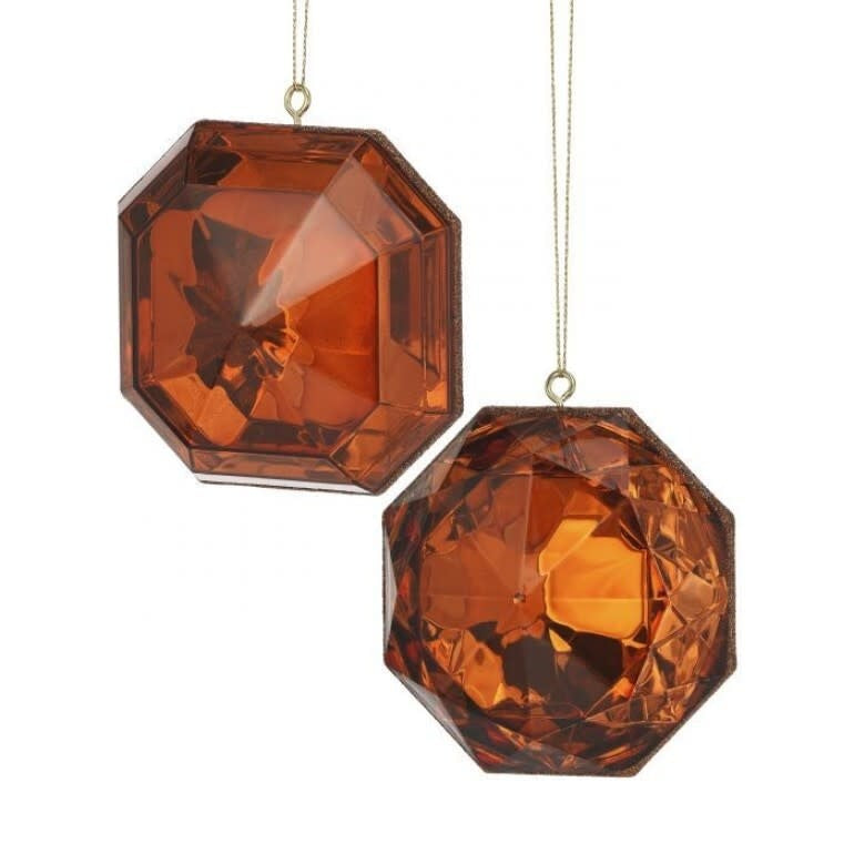 Two copper-colored, faceted acrylic gem ornaments with a geometric, multi-sided silhouette.