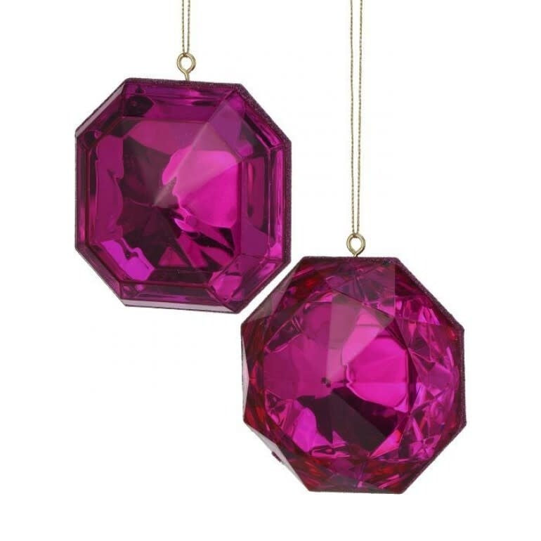 Two fuchsia-colored, faceted acrylic gem ornaments with gold hanging strings.