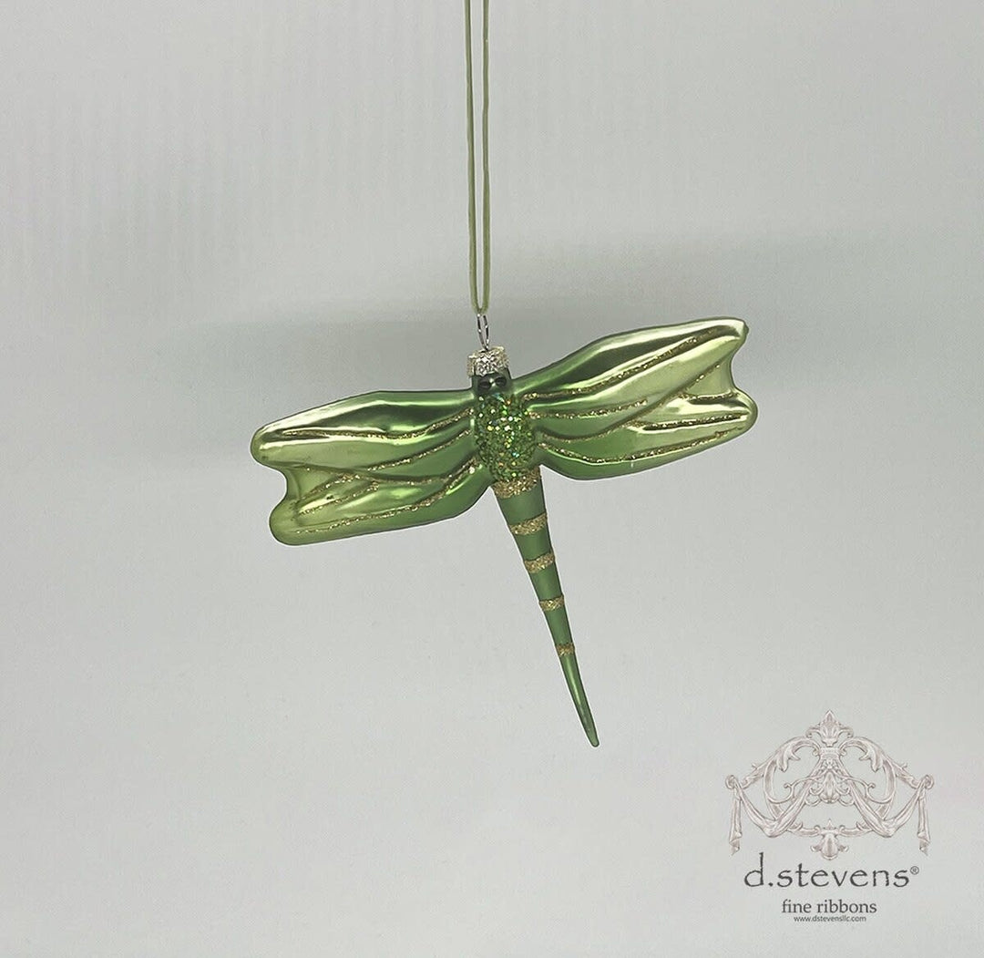 A 4-inch green glass dragonfly ornament with gold glitter accents on its wings and body.